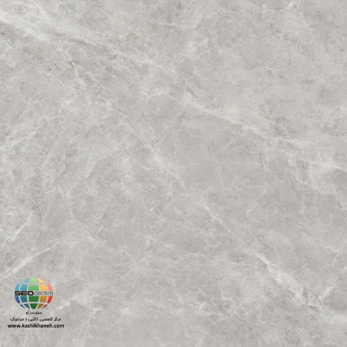 سرامیک پرسلان فلور طوسی تیره مات کاشی آسیا 120×120 انتخاب پوشش مناسب برای کف و دیوار ساختمان یکی از مهم‌ترین تصمیمات در طراحی داخلی است. کیفیت متریال، دوام، زیبایی و هماهنگی با سبک معماری، همگی در ارزش نهایی یک فضا تأثیرگذار هستند. در میان محصولات موجود در بازار، سرامیک پرسلان فلور طوسی تیره مات کاشی آسیا 120×120 به دلیل ظاهر مدرن، کیفیت ساخت بالا و مقاومت فوق‌العاده، به یکی از گزینه‌های محبوب معماران، طراحان داخلی و سازندگان ساختمان تبدیل شده است. رنگ طوسی تیره این محصول، الهام‌گرفته از بافت سنگ‌های طبیعی است و جلوه‌ای لوکس، آرام و امروزی به محیط می‌بخشد. استفاده از لعاب مات نیز باعث شده است تا سطح سرامیک نور را به‌صورت ملایم بازتاب دهد و حس طبیعی‌تری ایجاد کند. همین ویژگی باعث می‌شود این محصول در فضاهای مینیمال، مدرن، صنعتی و حتی کلاسیک نیز به‌راحتی مورد استفاده قرار گیرد. ابعاد بزرگ 120×120 سانتی‌متر نیز یکی دیگر از مزایای مهم این محصول است. هرچه ابعاد سرامیک بزرگ‌تر باشد، تعداد بندها کمتر شده و در نتیجه سطحی یکدست‌تر، زیباتر و چشم‌نوازتر ایجاد می‌شود. این ویژگی مخصوصاً در سالن‌های بزرگ، لابی‌ها، ویلاها و واحدهای لوکس اهمیت زیادی دارد.