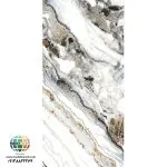 سرامیک خاک سفید تیارا براق کاشی ماهان سرام سرامیک خاک سفید تیارا براق کاشی ماهان سرام در ابعاد 120×60 سانتی‌متر معرفی شده و در تصویر آن، زمینه‌ای سفید و روشن با رگه‌های طوسی، خاکستری تیره، مشکی و طلایی دیده می‌شود. ترکیب این رنگ‌ها، ظاهر سنگ‌های طبیعی رگه‌دار را تداعی می‌کند و امکان استفاده از سرامیک خاک سفید تیارا براق کاشی ماهان سرام را در دکوراسیون‌های لوکس، مدرن و مینیمال فراهم می‌سازد. سطح براق، جلوه رگه‌های طرح و ابعاد نسبتاً بزرگ سرامیک خاک سفید تیارا براق کاشی ماهان سرام باعث می‌شود هنگام انتخاب آن، علاوه بر زیبایی، به محل نصب، نورپردازی، رنگ سایر اجزای دکوراسیون و روش اجرا نیز توجه داشته باشید. در ادامه، ویژگی‌های ظاهری سرامیک خاک سفید تیارا براق کاشی ماهان سرام، مزایا، کاربردها، نکات نصب و نگهداری و عوامل مؤثر بر قیمت آن را بررسی می‌کنیم تا بتوانید با شناخت بیشتری برای خرید تصمیم بگیرید. انتخاب سرامیک مناسب یکی از تصمیم‌های مهم در طراحی و تکمیل ساختمان است؛ زیرا طرح، رنگ، ابعاد و نوع سطح آن می‌توانند تأثیر زیادی بر ظاهر نهایی فضا داشته باشند. اگر به دکوراسیون مدرن، رنگ‌های روشن و طرح سنگ مرمر علاقه دارید، سرامیک خاک سفید تیارا براق کاشی ماهان سرام یکی از گزینه‌هایی است که می‌توانید هنگام انتخاب پوشش مناسب برای ساختمان بررسی کنید.